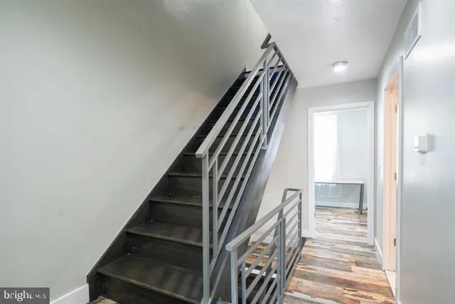 a view of entryway and hall with wooden floor