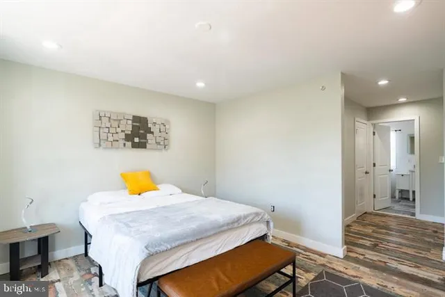 a bedroom with a bed and painting on the wall