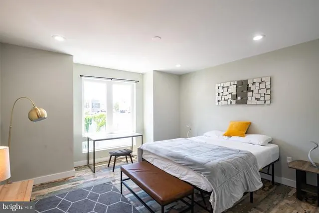 a bedroom with a bed and a window