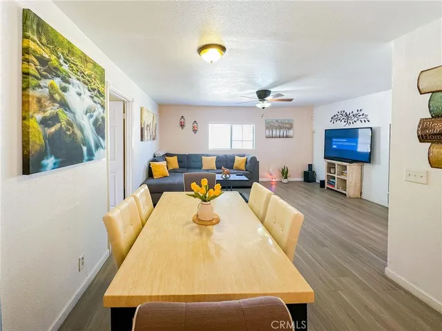 a living room with furniture wooden floor and a window