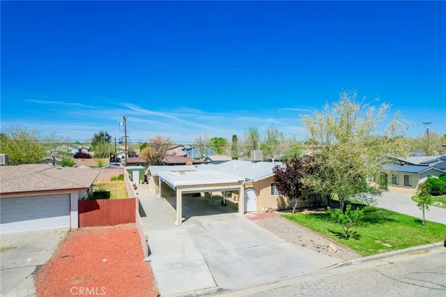an aerial view of a house with a yard