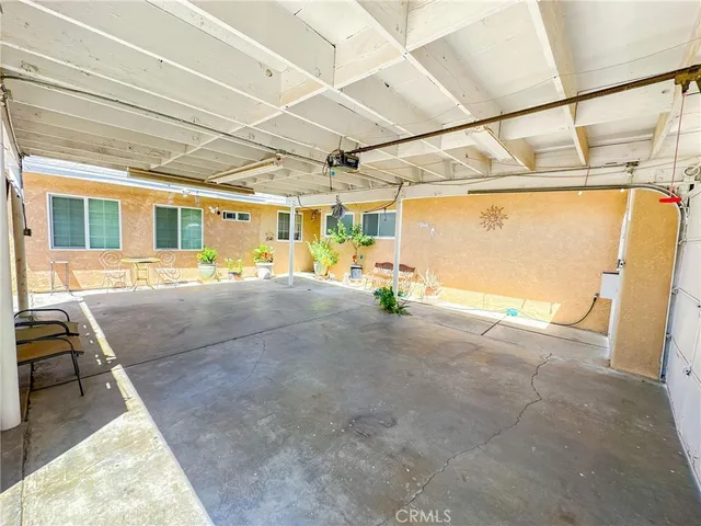 a kitchen with stainless steel appliances granite countertop a refrigerator sink and wooden cabinets