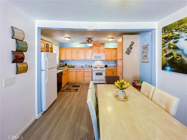 a large kitchen with a table and chairs in it