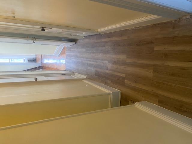 87-28 87th Street Queens, NY 11421 - Photo 14 of 15 a view of a hallway with wooden floor