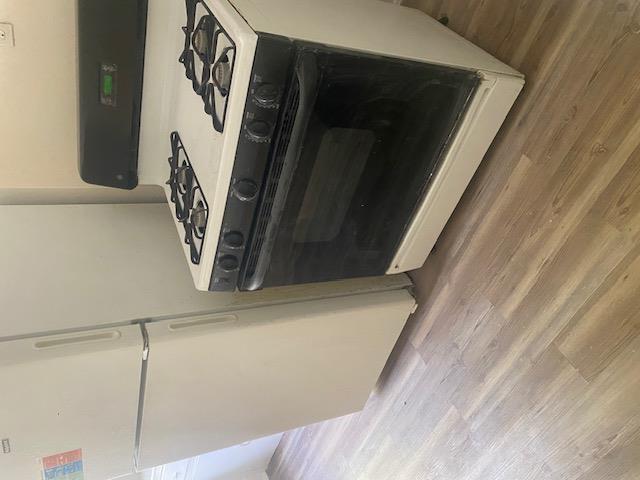 87-28 87th Street Queens, NY 11421 - Photo 10 of 15 a stove top oven sitting inside of a kitchen