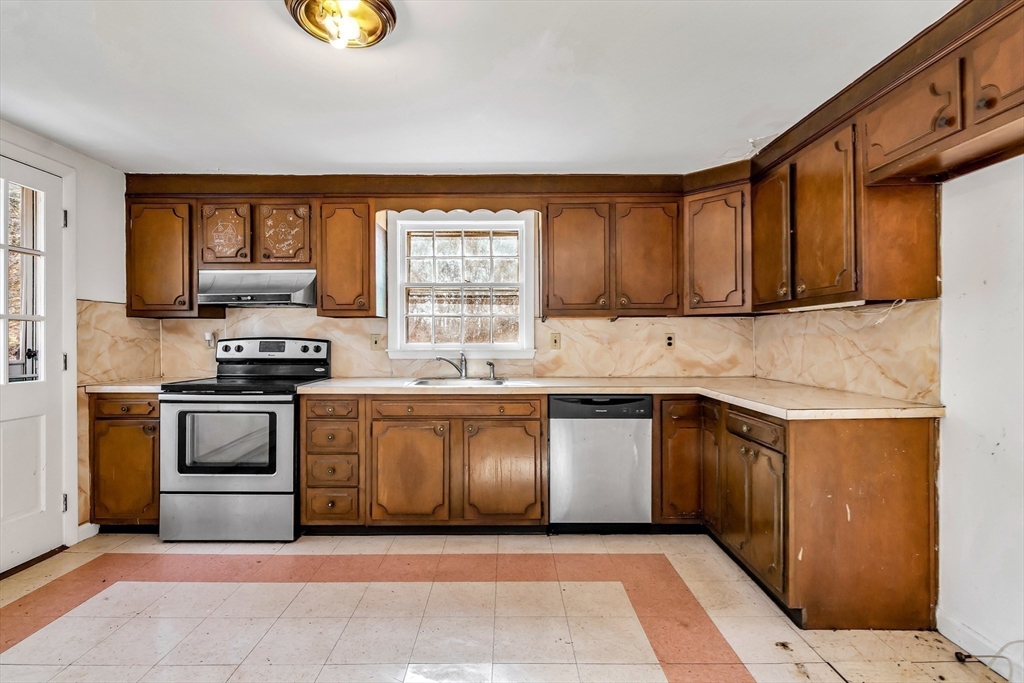 955 Hale Street Beverly, MA 01915 - Photo 14 of 32 a kitchen with a stove a sink and a microwave