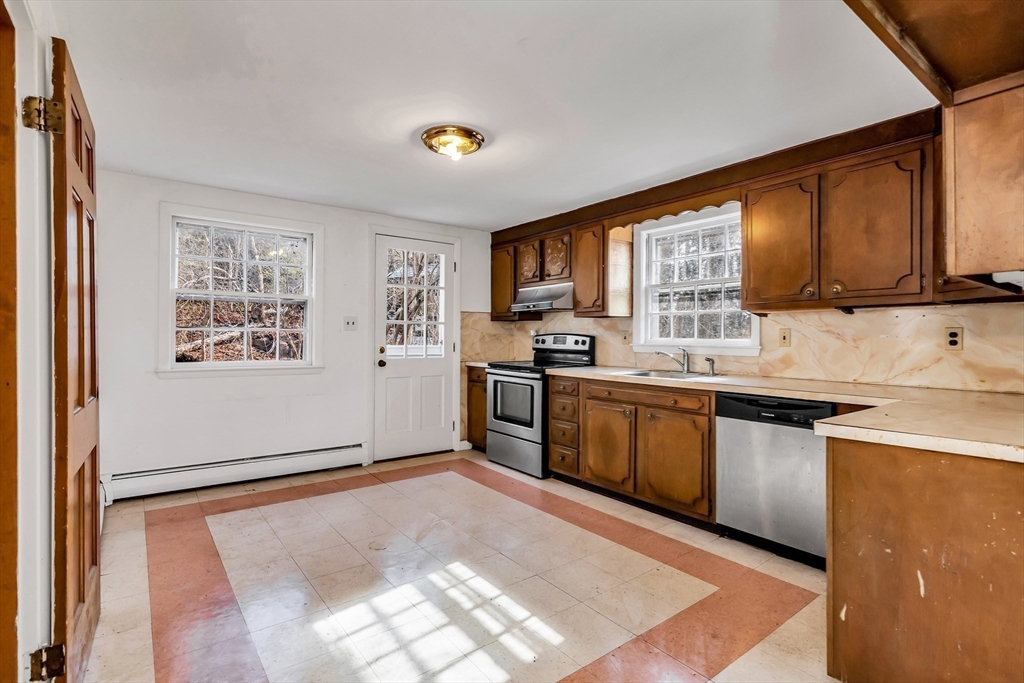 955 Hale Street Beverly, MA 01915 - Photo 15 of 32 a kitchen with stainless steel appliances granite countertop a refrigerator stove top oven and sink