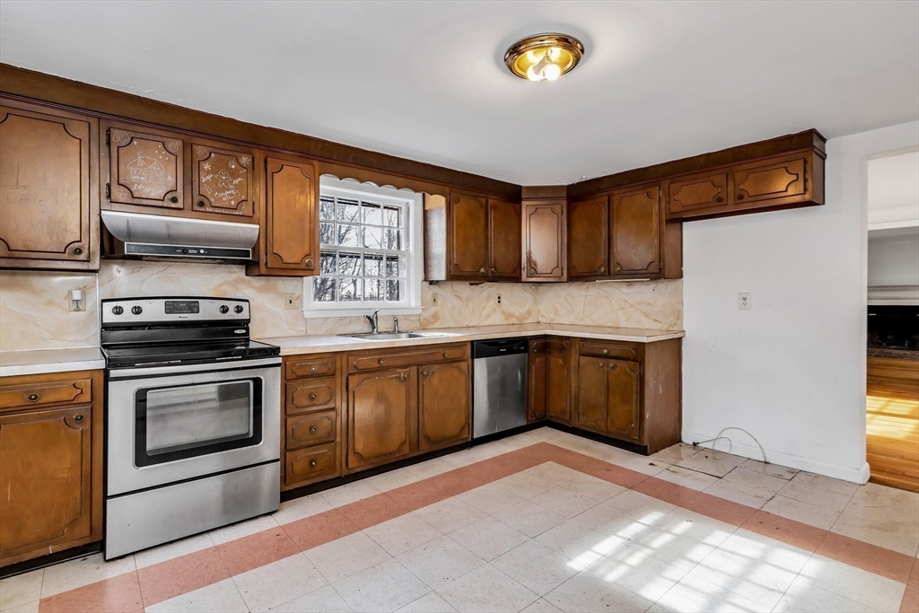 955 Hale Street Beverly, MA 01915 - Photo 16 of 32 a kitchen with stainless steel appliances granite countertop a stove a sink dishwasher and a refrigerator