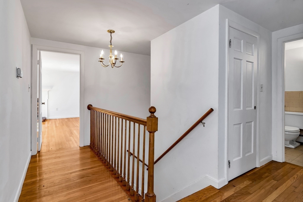 955 Hale Street Beverly, MA 01915 - Photo 19 of 32 a view of a hallway with wooden floor and staircase