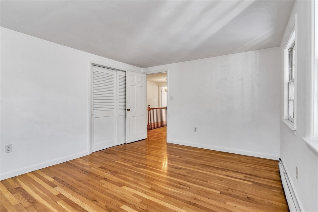 955 Hale Street Beverly, MA 01915 - Photo 22 of 32 a view of an empty room with wooden floor and a window