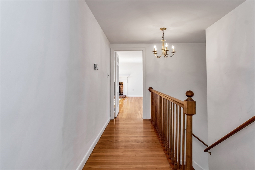 955 Hale Street Beverly, MA 01915 - Photo 25 of 32 a view of a hallway with wooden floor and staircase