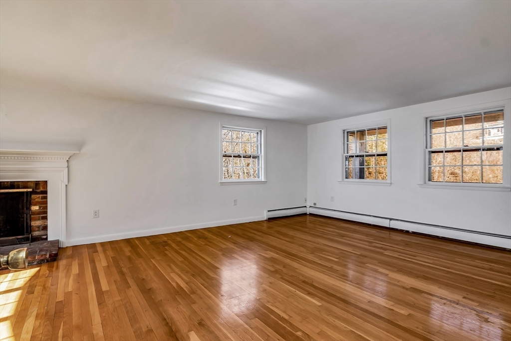 955 Hale Street Beverly, MA 01915 - Photo 26 of 32 an empty room with wooden floor and windows