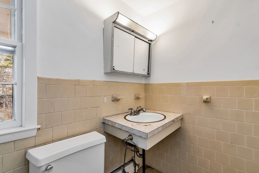 955 Hale Street Beverly, MA 01915 - Photo 31 of 32 a bathroom with a sink a toilet and mirror