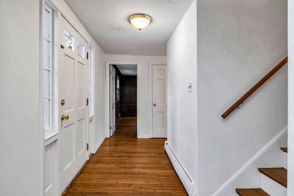 955 Hale Street Beverly, MA 01915 - Photo 10 of 32 a view of a hallway with wooden floor and staircase