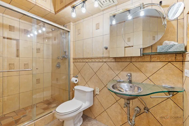 a bathroom with a sink toilet and shower