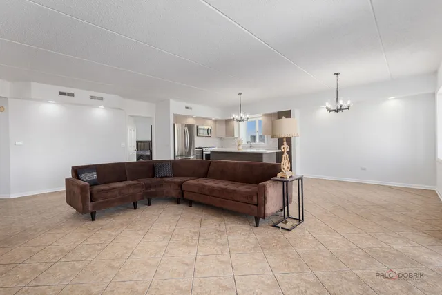 a living room with furniture and a ceiling fan