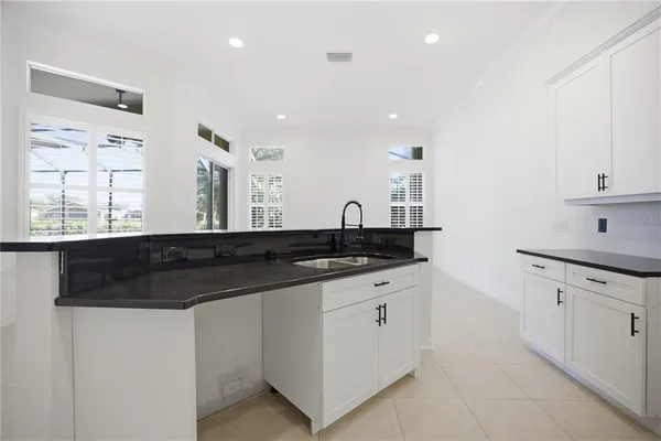 a kitchen with granite countertop a sink and cabinets