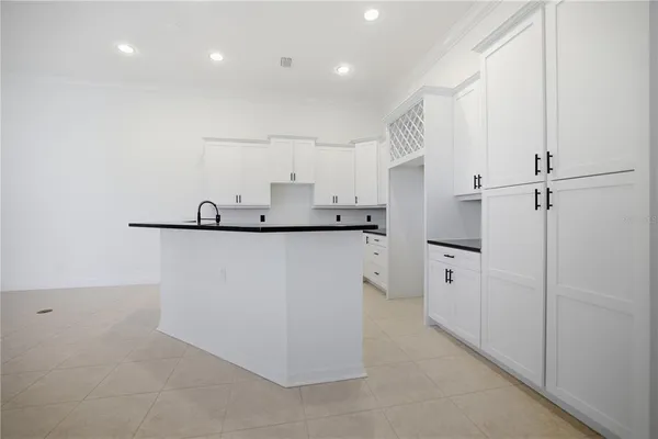 a kitchen with cabinets and a refrigerator