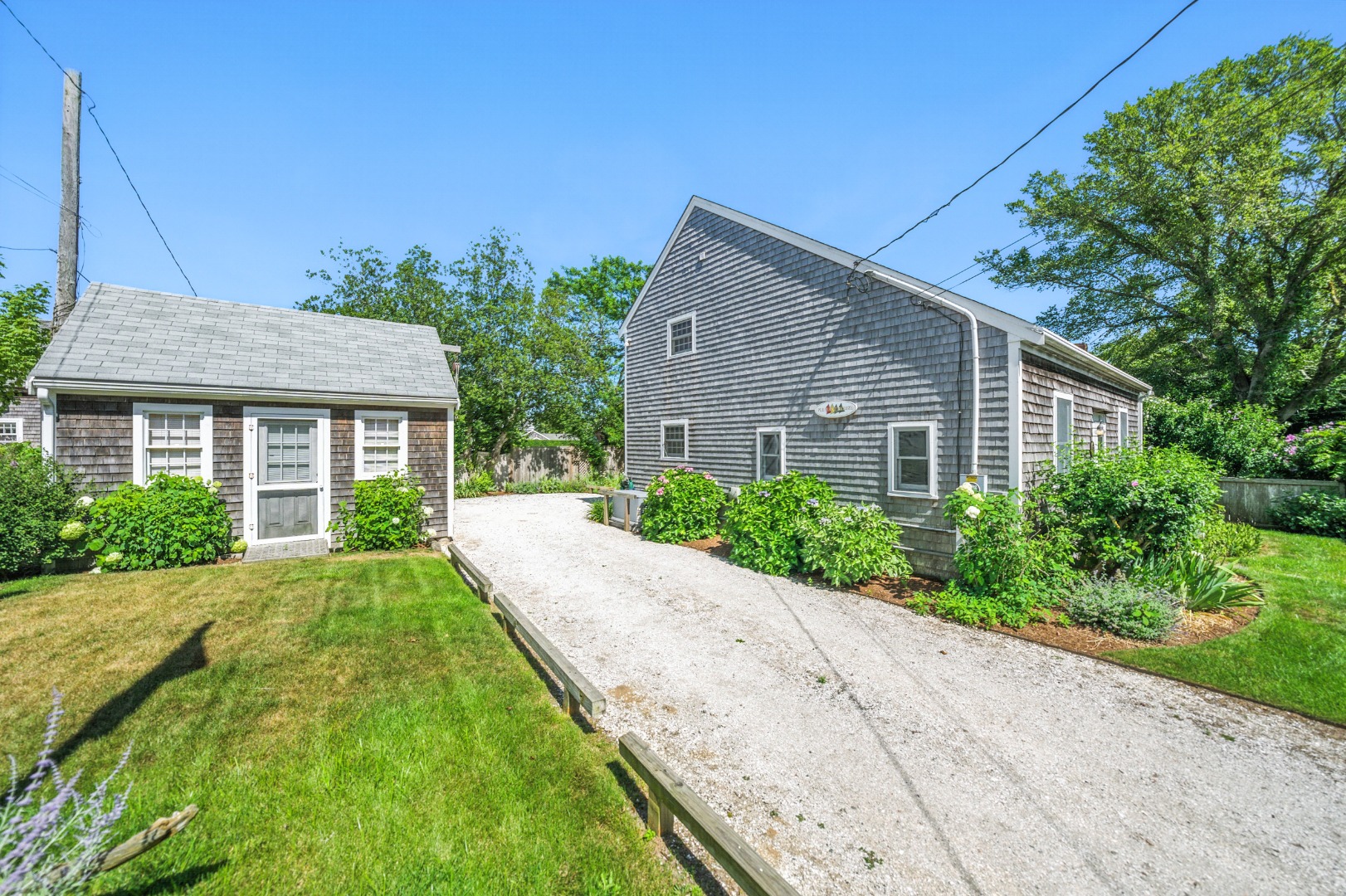 52 Pleasant Street Nantucket, MA 02554 - Photo 32 of 36 a front view of a house with a yard