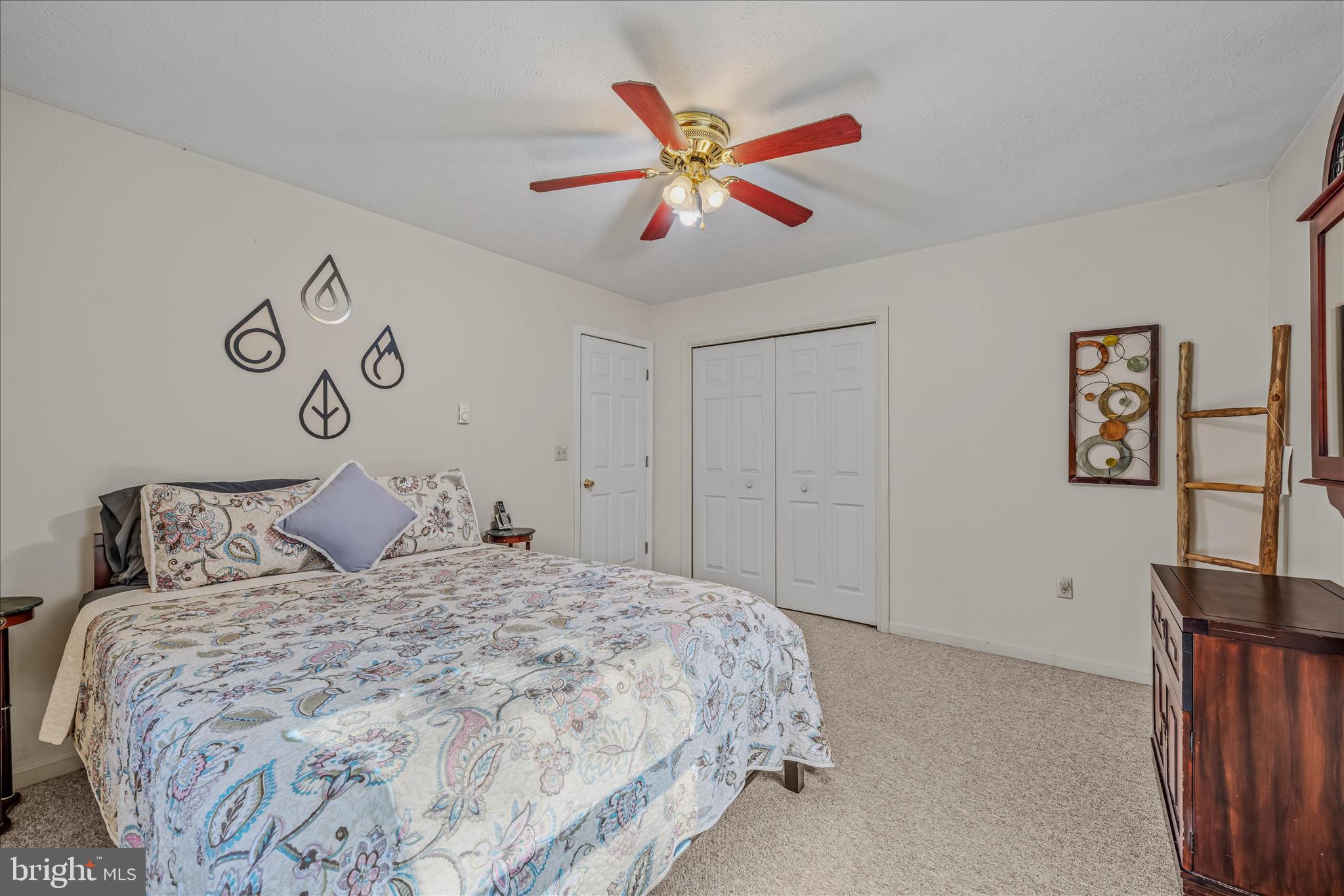 67 Tranquil Way Berkeley Springs, WV 25411 - Photo 17 of 37 a bedroom with a large bed and a chandelier