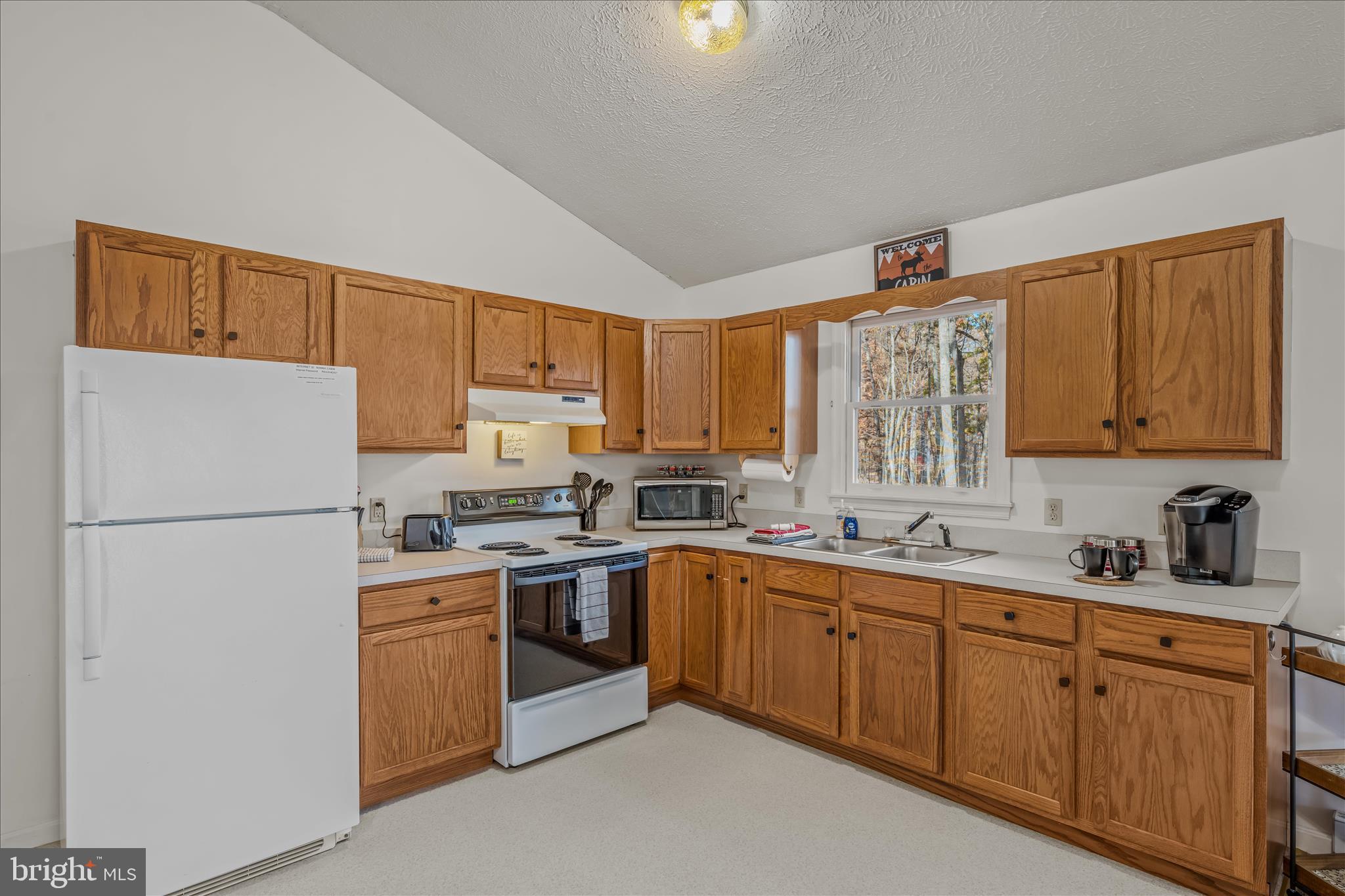67 Tranquil Way Berkeley Springs, WV 25411 - Photo 7 of 37 a kitchen with sink a microwave and cabinets