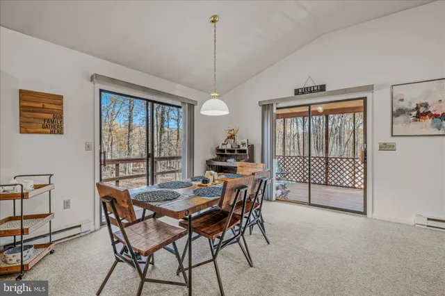 a dining room with furniture a chandelier and window