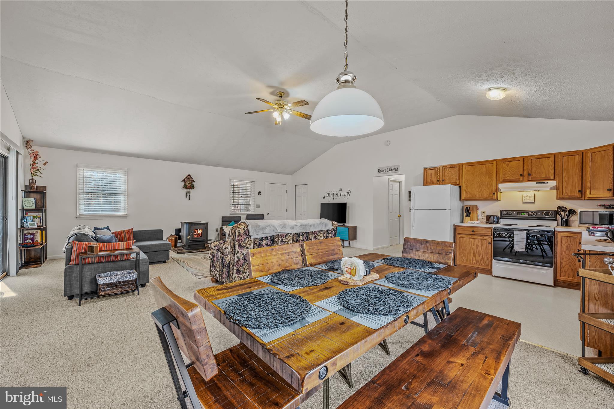 67 Tranquil Way Berkeley Springs, WV 25411 - Photo 10 of 37 a living room with furniture kitchen view and a chandelier