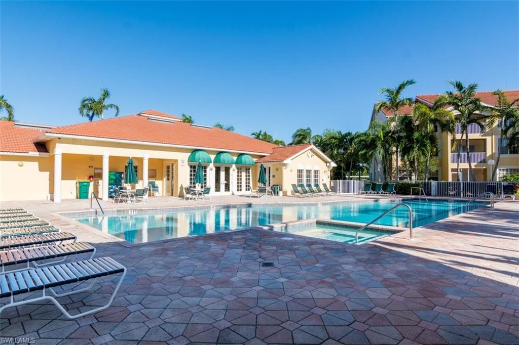 4635 St Croix Lane, Unit 1218 Naples, FL 34109 - Photo 23 of 40 Community pool with a hot tub, a patio area, and french doors