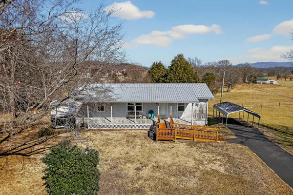 a view of a house with backyard porch and sitting area