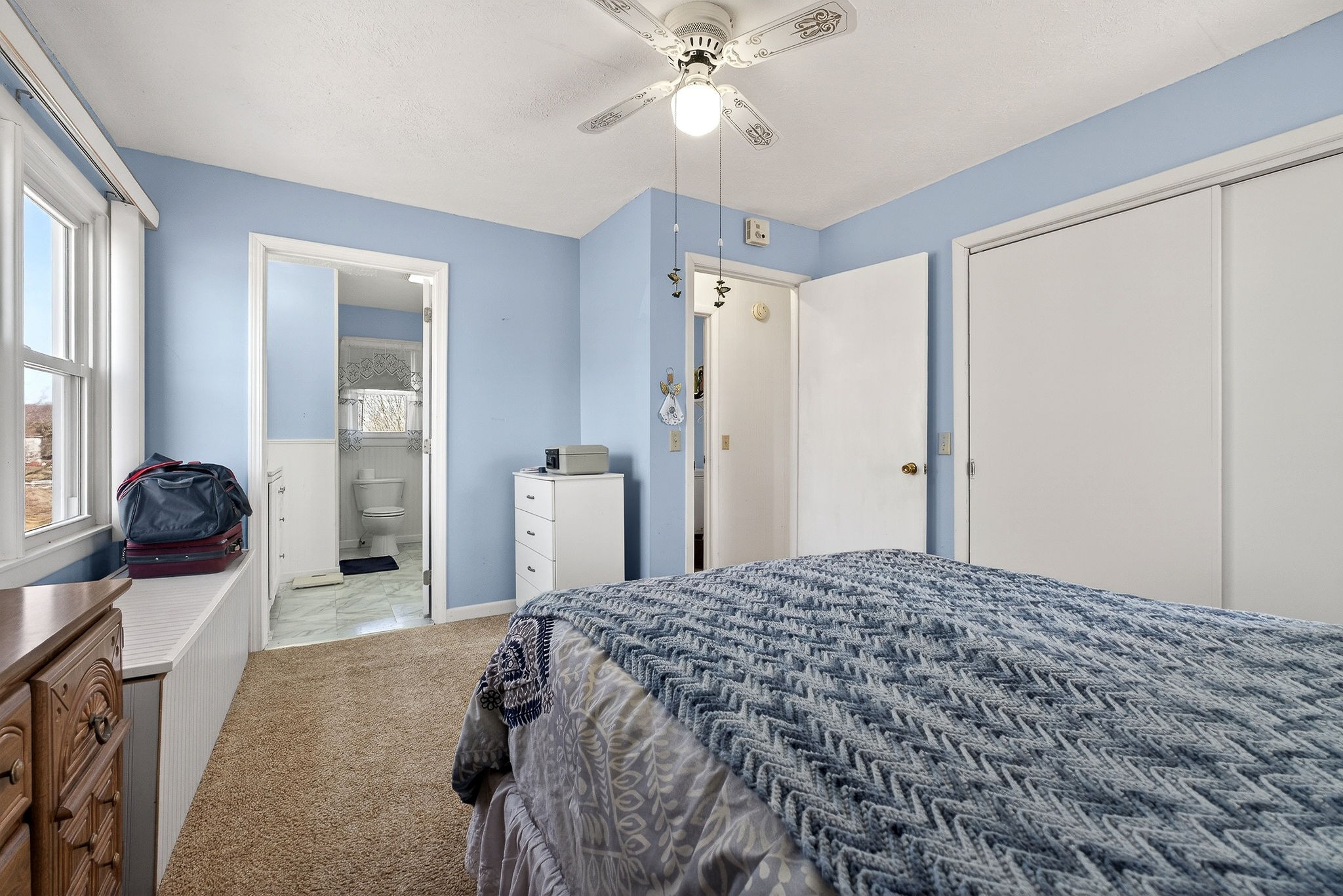 566 Turntable Road Sparta, TN 38583 - Photo 20 of 48 a bedroom with a bed and a chandelier
