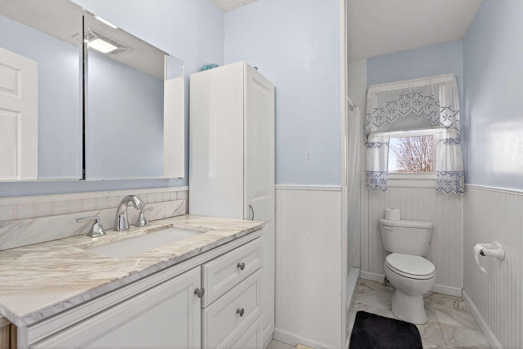 566 Turntable Road Sparta, TN 38583 - Photo 21 of 48 a bathroom with a granite countertop toilet sink and a mirror