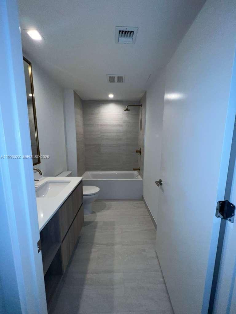 77 Southeast 5th, Unit 2004 Miami, FL 32311 - Photo 11 of 32 a bathroom with a sink and mirror