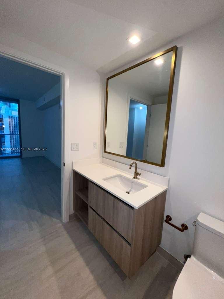 77 Southeast 5th, Unit 2004 Miami, FL 32311 - Photo 12 of 32 a bathroom with a double vanity sink mirror and toilet