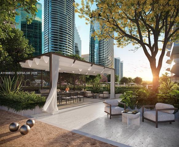 77 Southeast 5th, Unit 2004 Miami, FL 32311 - Photo 27 of 32 a view of a patio with couches and table and chairs and potted plants
