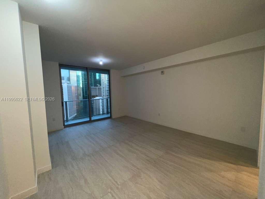 77 Southeast 5th, Unit 2004 Miami, FL 32311 - Photo 4 of 32 an empty room with wooden floor and windows