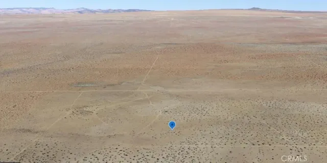 a view of an ocean beach and mountain