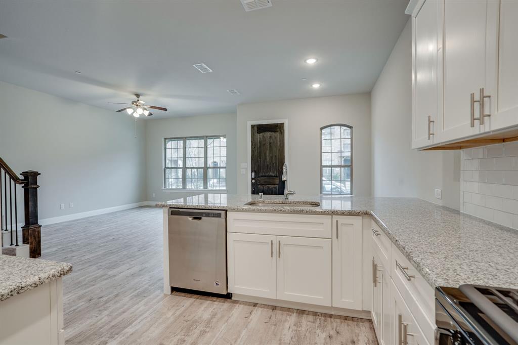 6217 Rainbow Valley Place Frisco, TX 75035 - Photo 16 of 30 a kitchen with granite countertop a sink stainless steel appliances and cabinets