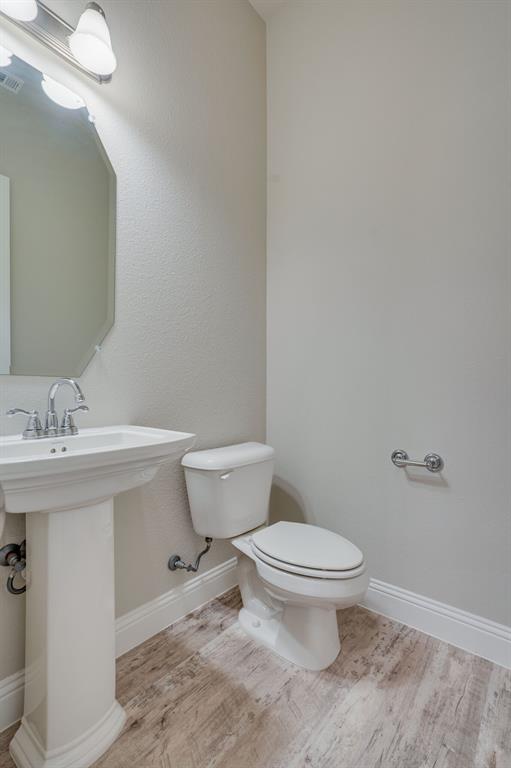 6217 Rainbow Valley Place Frisco, TX 75035 - Photo 17 of 30 a bathroom with a sink a toilet and a mirror