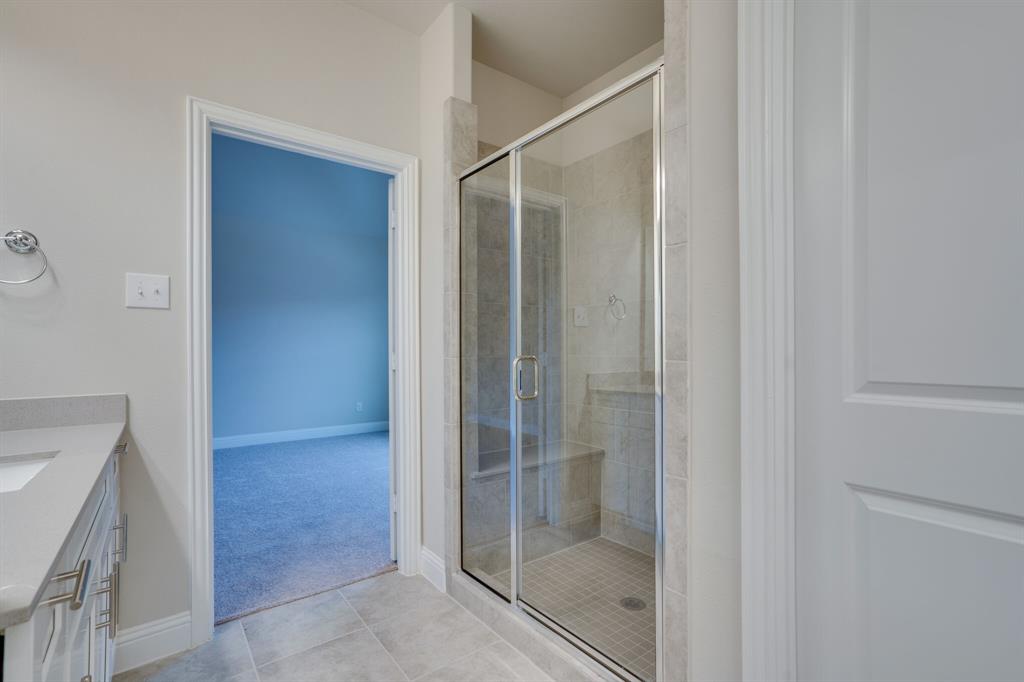 6217 Rainbow Valley Place Frisco, TX 75035 - Photo 24 of 30 a bathroom with a glass shower door