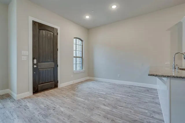 an empty room with windows and closet