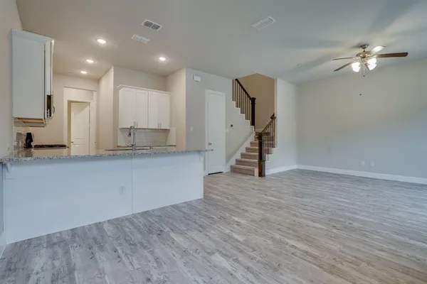 a view of kitchen with wooden floor and electronic appliances