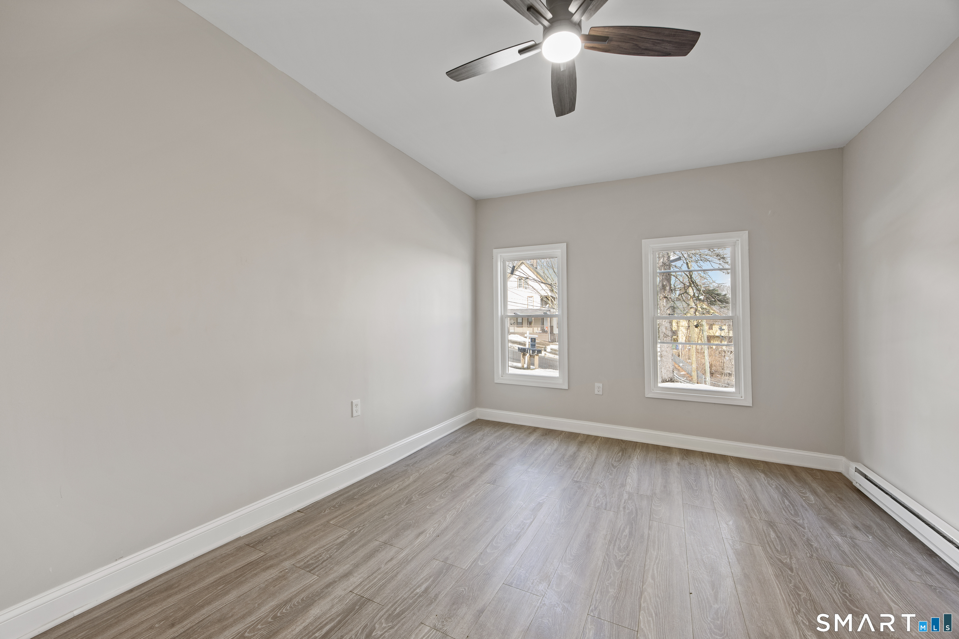 465 Washington Avenue Waterbury, CT 06708 - Photo 11 of 34 a view of an empty room with a window and wooden floor