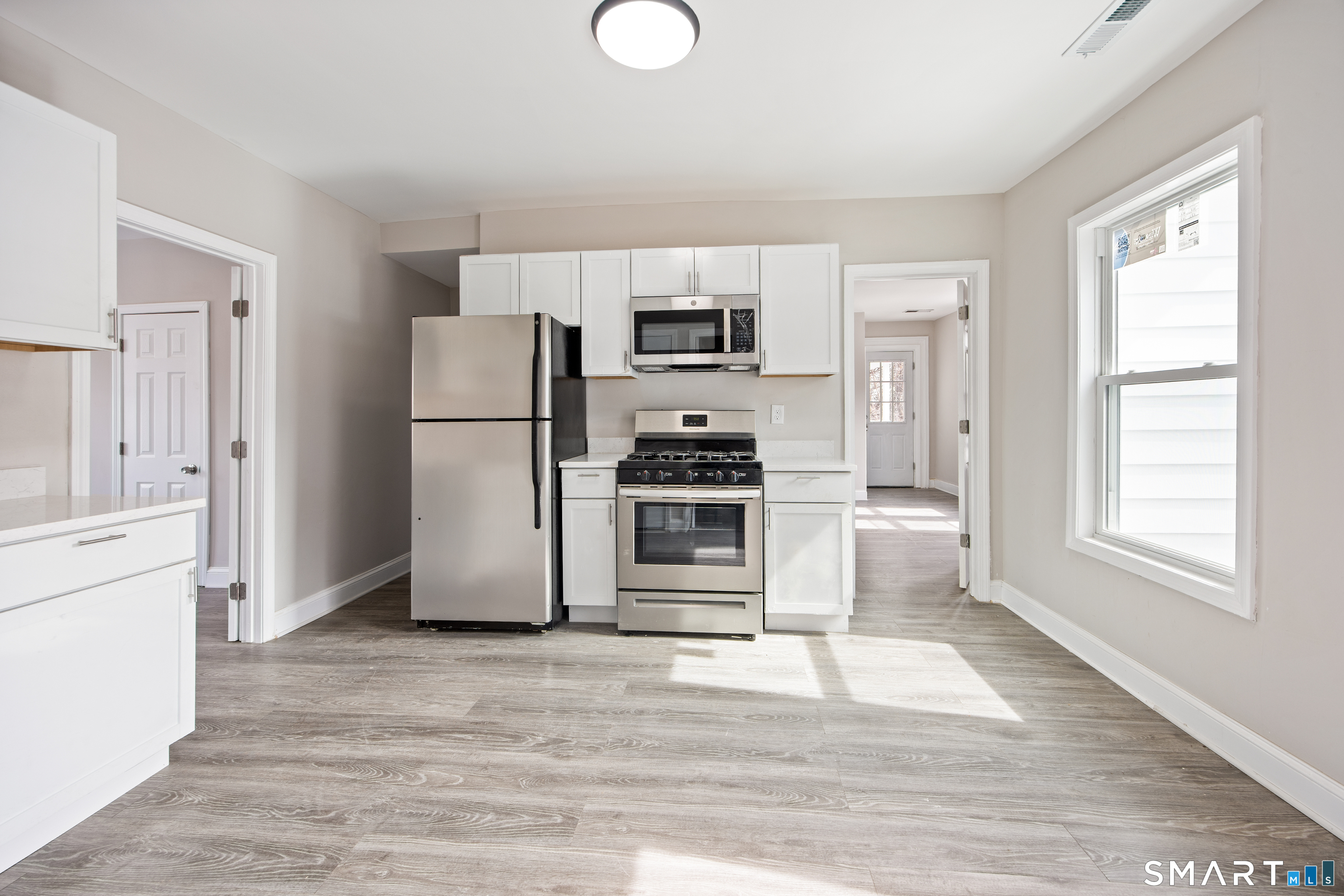 465 Washington Avenue Waterbury, CT 06708 - Photo 15 of 34 a kitchen with a refrigerator and a stove top oven
