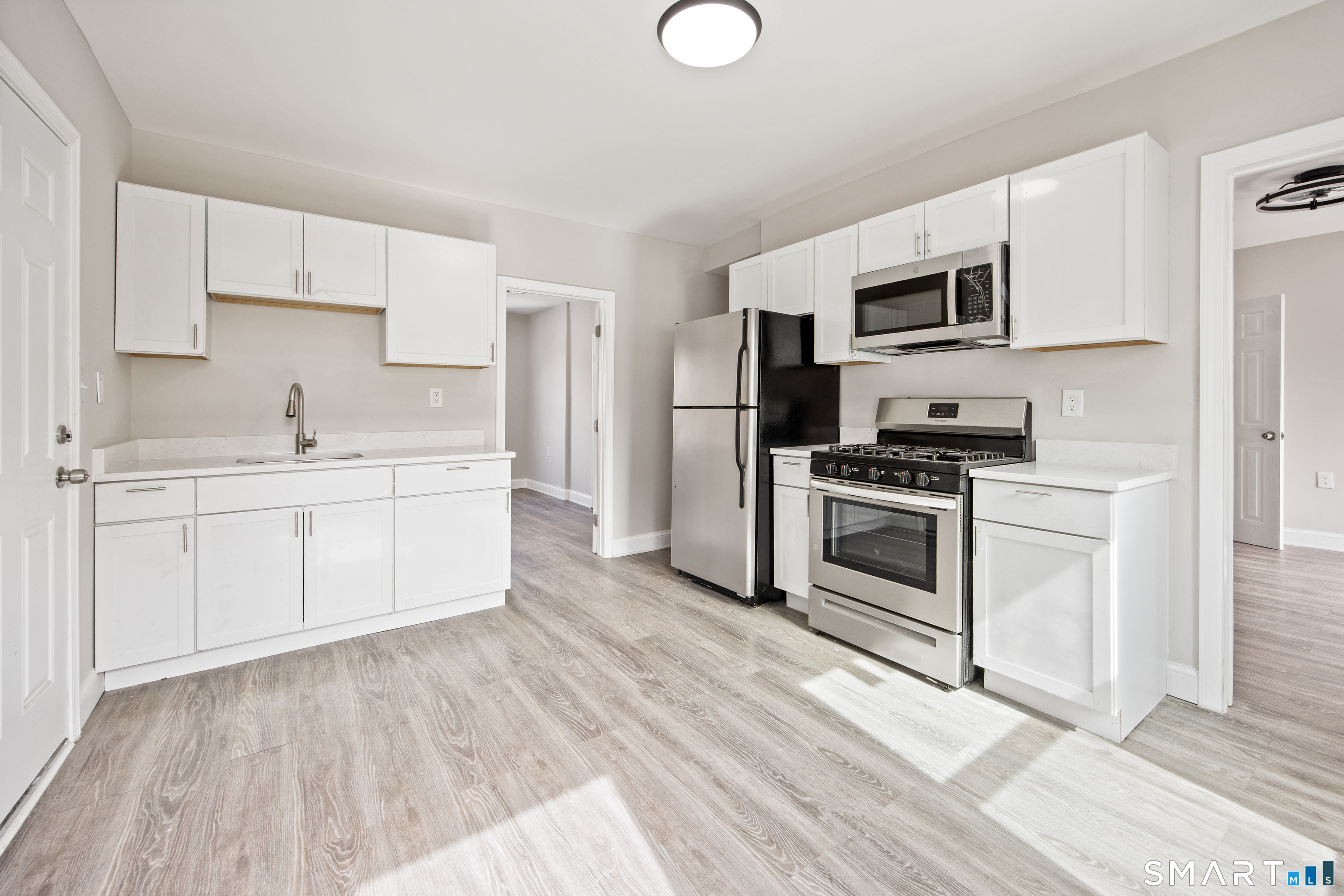 465 Washington Avenue Waterbury, CT 06708 - Photo 16 of 34 a kitchen with stainless steel appliances a white stove top oven and sink
