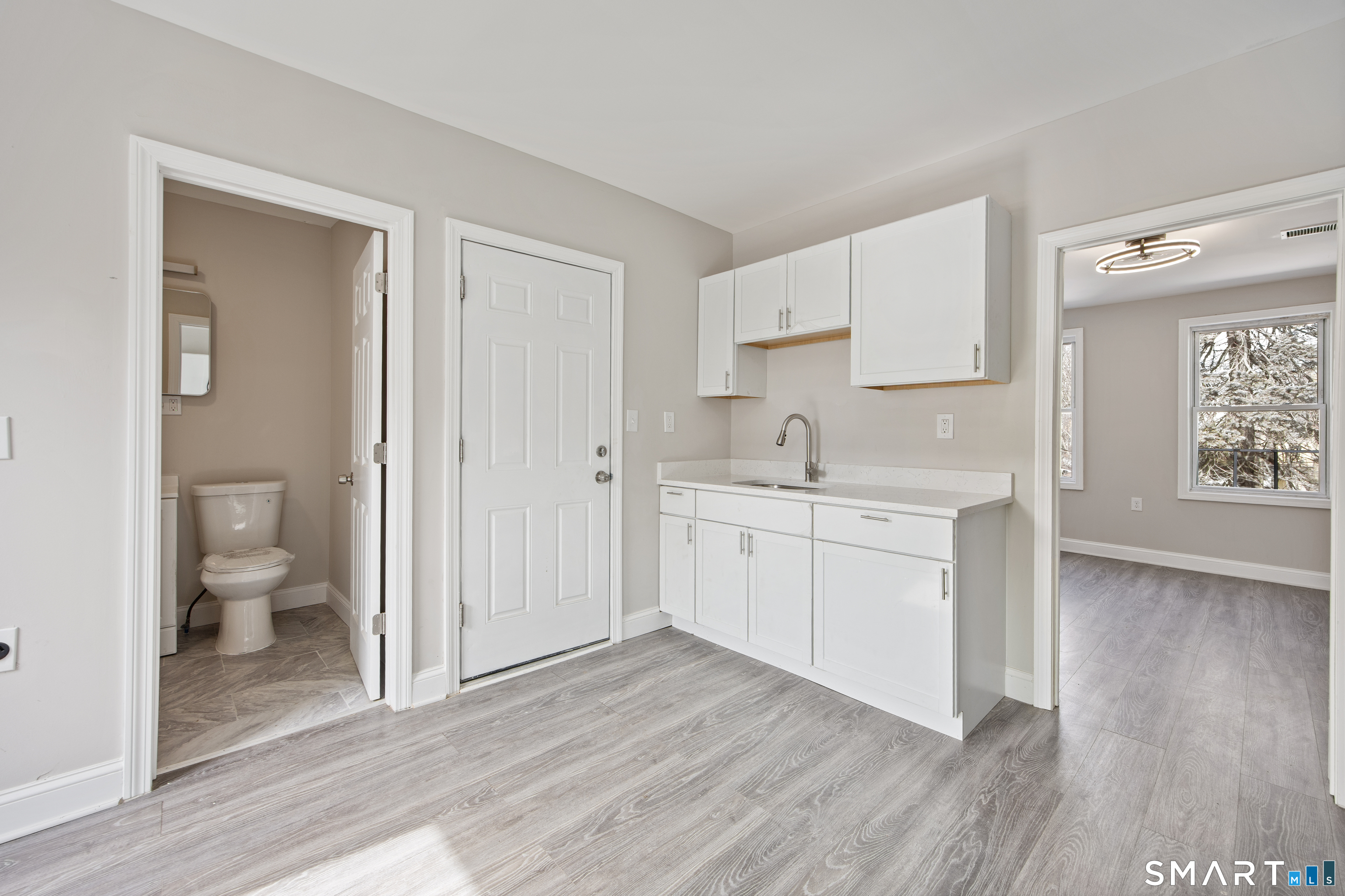 465 Washington Avenue Waterbury, CT 06708 - Photo 17 of 34 a room with a white cabinets and wooden floor