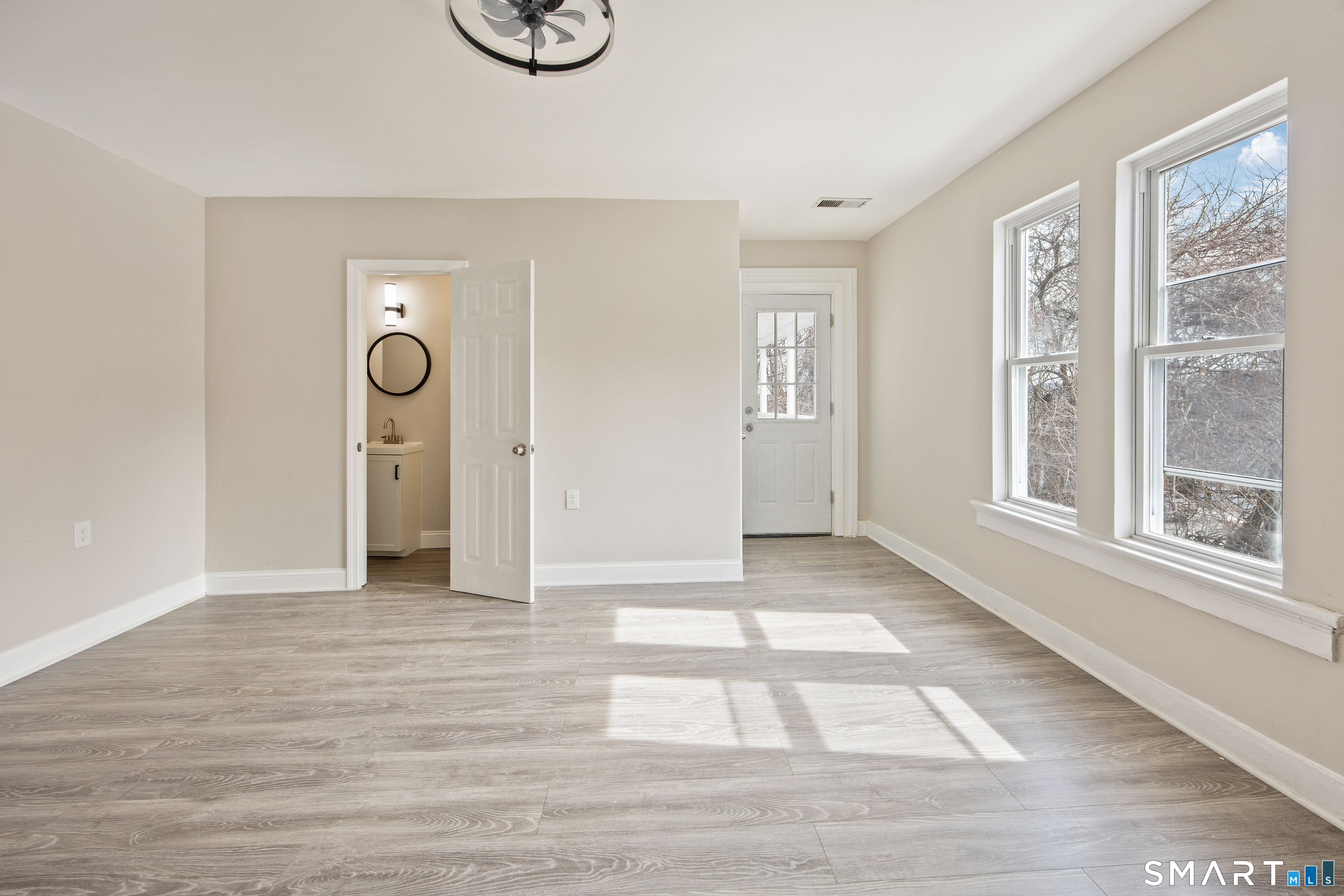 465 Washington Avenue Waterbury, CT 06708 - Photo 18 of 34 a view of an empty room with wooden floor and windows