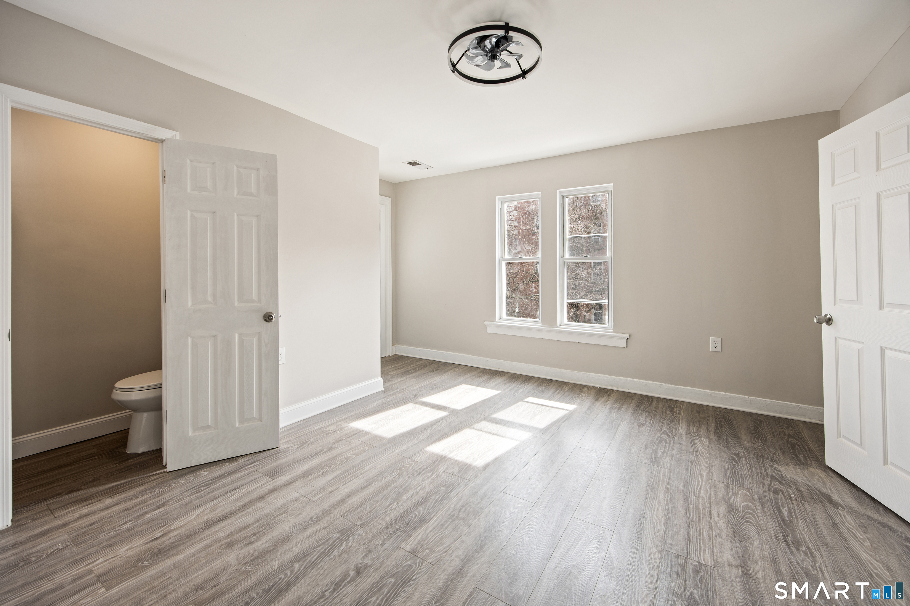 465 Washington Avenue Waterbury, CT 06708 - Photo 19 of 34 a view of an empty room with a window and wooden floor