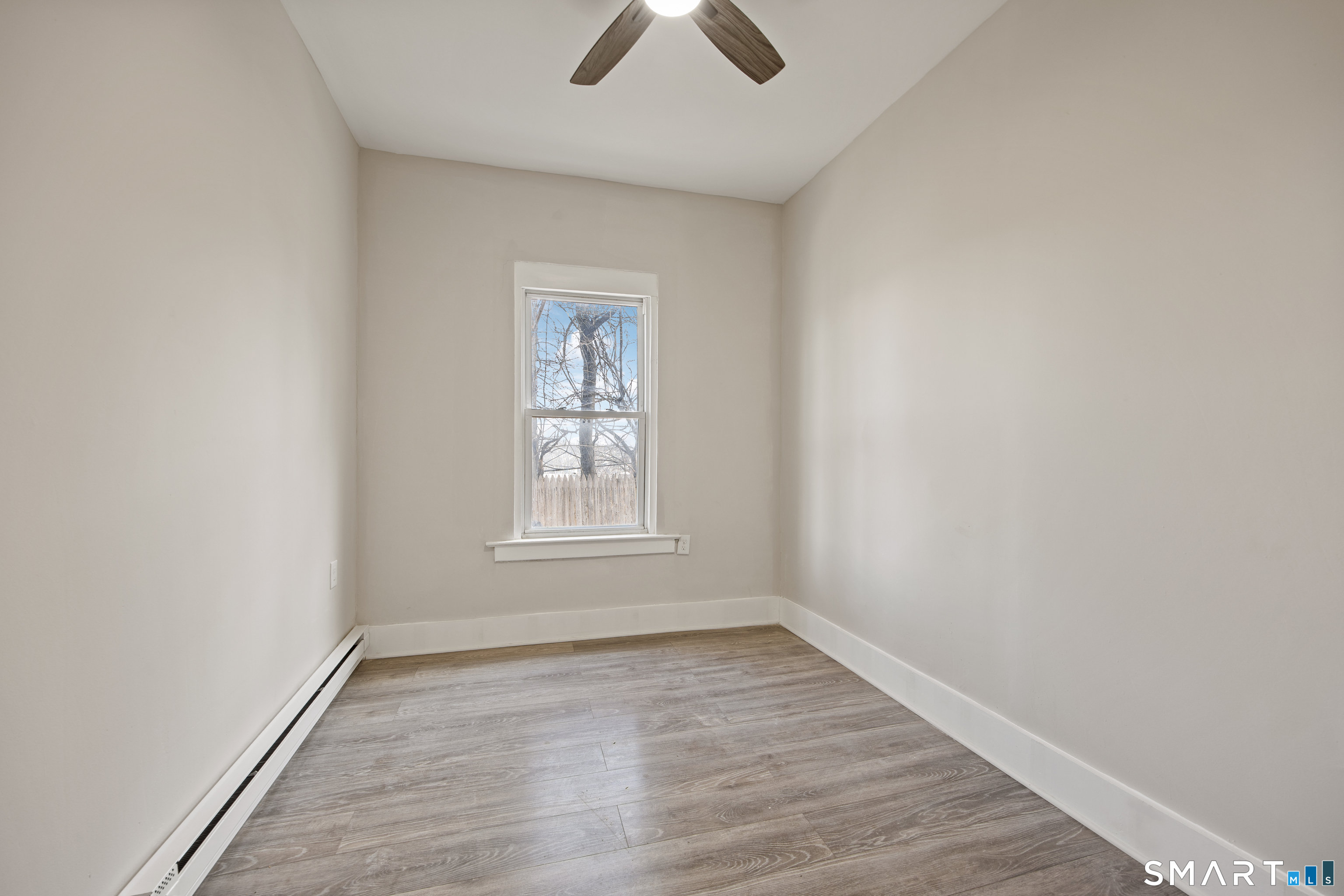 465 Washington Avenue Waterbury, CT 06708 - Photo 20 of 34 an empty room with ceiling fan and window