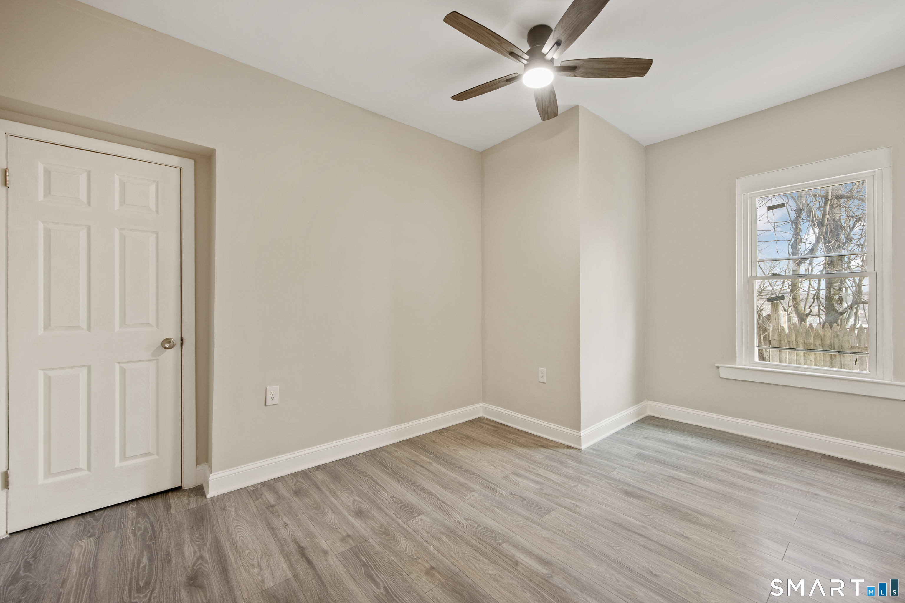465 Washington Avenue Waterbury, CT 06708 - Photo 22 of 34 a view of an empty room with wooden floor and a window