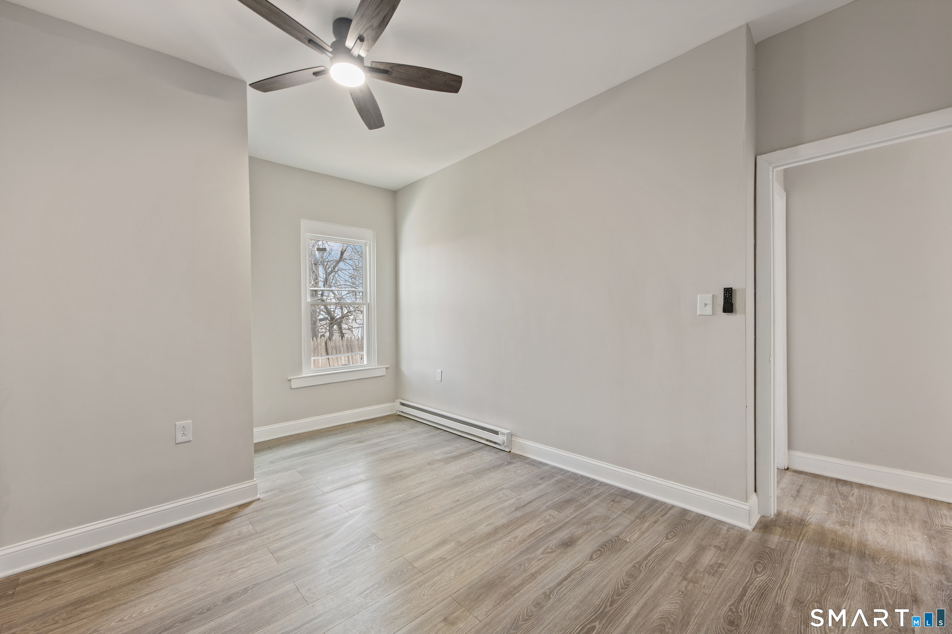 465 Washington Avenue Waterbury, CT 06708 - Photo 23 of 34 wooden floor in an empty room with a window